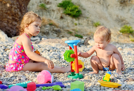 children on the beach playing toysの写真素材