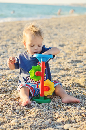 boy on the beach playing with toyの写真素材
