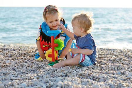 children on the beach playing toysの写真素材