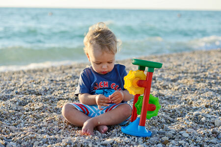boy on the beach playing with toyの写真素材