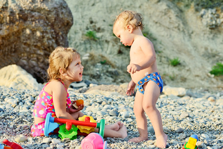 children on the beach playing toysの写真素材
