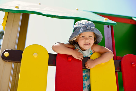 happy girl on the playground in summerの写真素材