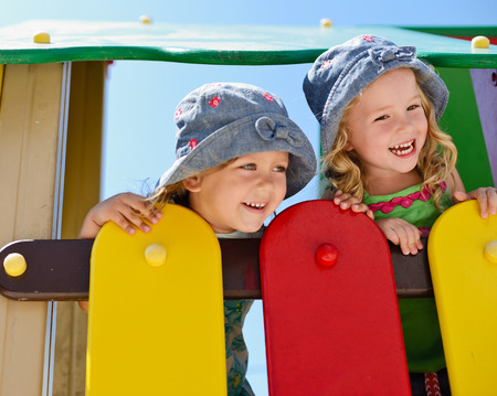 happy toddler girls on the playgroundの写真素材