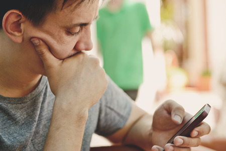 man looking in his phoneの写真素材