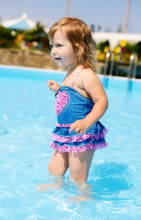 fashion toddler girl in the poolの写真素材