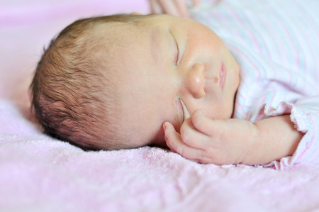 sweet dreams of newborn in soft focusの写真素材