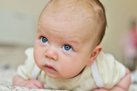 little baby trying to  keep headの写真素材