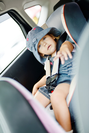 toddler girl in the car seatの写真素材