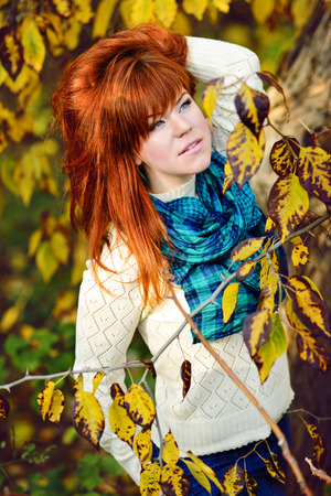 redhead young woman in fallの写真素材