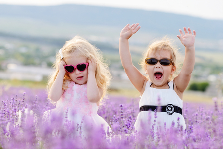 two happy girls in fieldの写真素材
