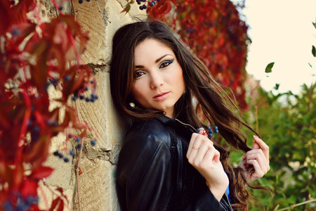 girl in fall near the wallの写真素材