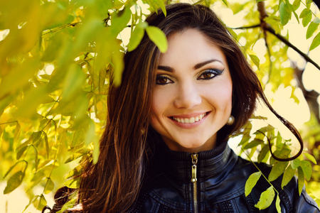 portrait of young woman in fall leavesの写真素材