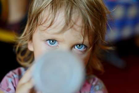 toddler with bottle in soft selective focusの写真素材