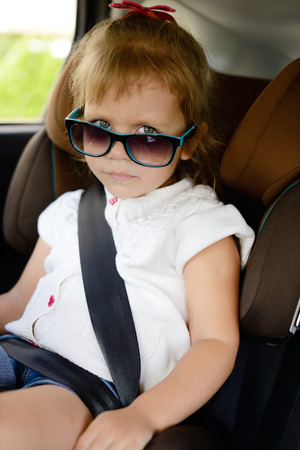 cute girl in car seatの写真素材