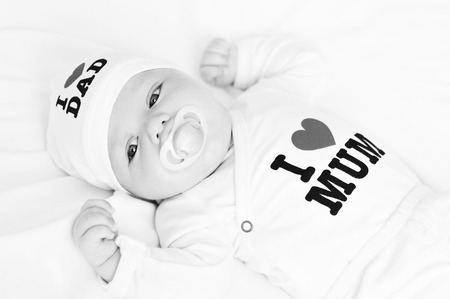 newborn girl wearing clothing with love to mum and dad (not trademark)の写真素材