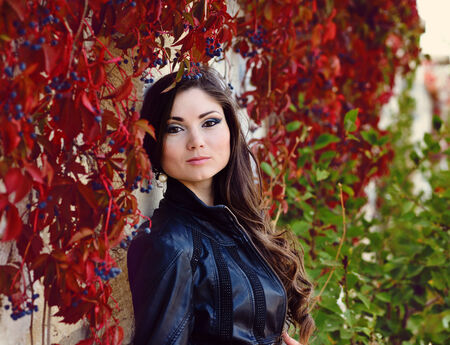 girl in fall near the wallの写真素材