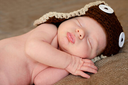 sleeping  newborn wearing funny hatの写真素材