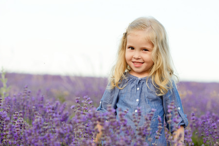 happy smiling girl in lavender fieldの写真素材
