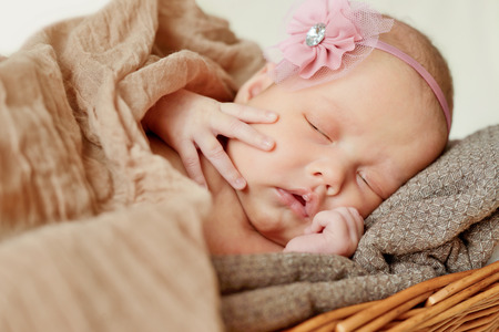 lovely newborn girl is sleepingの写真素材