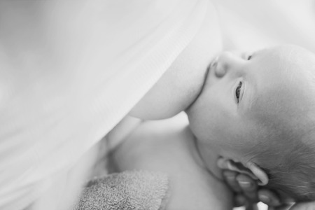 mother feeding her newborn with breastの写真素材