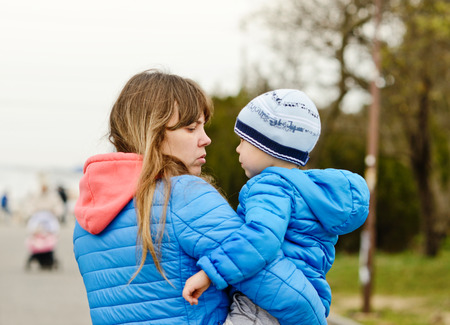 two-year-old toddler boy on the mother's handsの写真素材