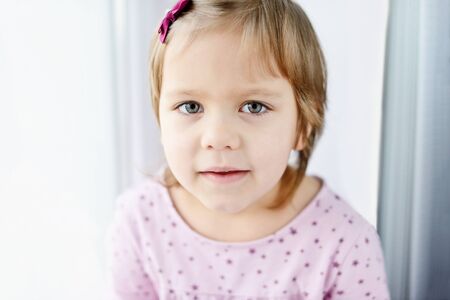portrait of sweet toddler girl at home