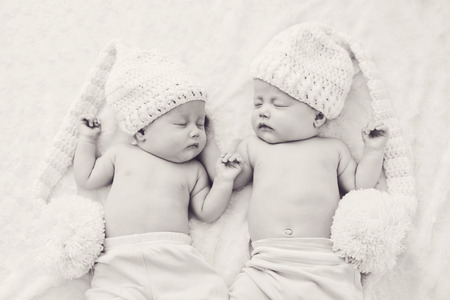 lovely twins are wearing funny long hatsの写真素材