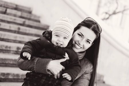 mom and baby son having fun outdoors