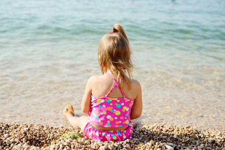 summer toddler girl playing in the seaの写真素材