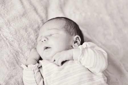 too funny sweet newborn girl is sleepingの写真素材
