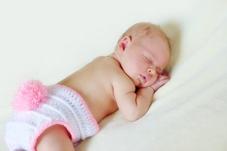 sweet sleeping newborn is wearing a bunny costumeの写真素材