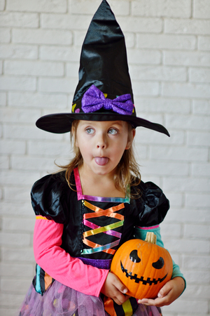 Portrait of girl wearing witch costume posing before cameraの写真素材