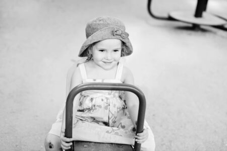happy toddler girl on the playground in summerの写真素材