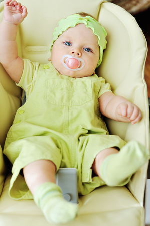 sweet little baby laying in bouncer chairの写真素材