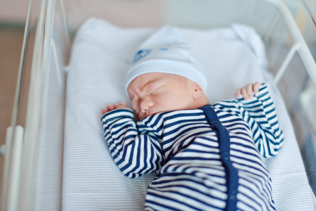 newborn baby laying in crib in  prenatal hospitalの写真素材