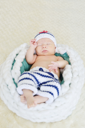 newborn boy is wearing a sailor coscumeの写真素材