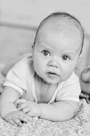 sweet blue eyed baby girl with saliva