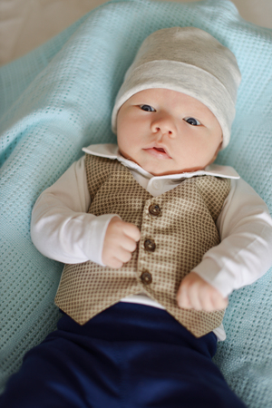 newborn tiny gentleman wearing little shirt and vest の写真素材