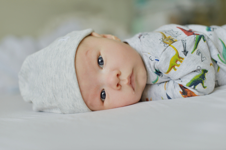 portrait of newborn baby laying on the bedの写真素材