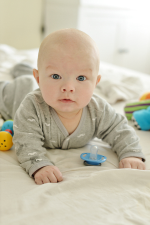 baby on the bed on the tummy