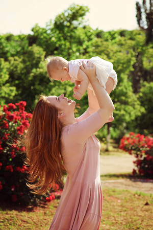 happy family in the blossom roses gardenの写真素材