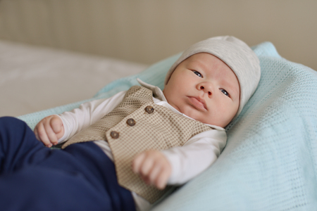 newborn tiny gentleman wearing little shirt and vestの写真素材