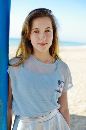 summer teen girl standing on the beachの写真素材