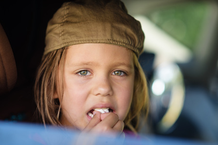 sweet girl looking from the car window