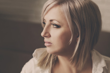 portrait of pensive woman with blonde hairの写真素材