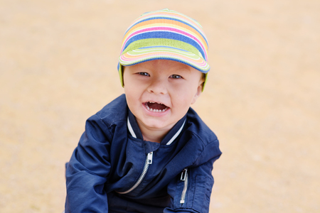 happy laughing  toddler boy on the playgroundの写真素材