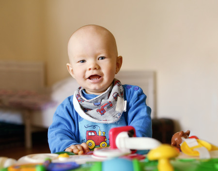 baby boy playing toy at the home