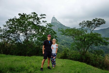Couple on vacation posing with symbol of  rio de janeiro on  the backgroundの写真素材