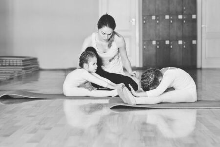trainer and two little girls in gymnastic classの写真素材