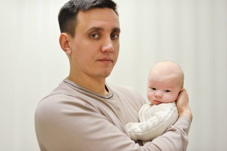 father holding newborn son at the homeの写真素材